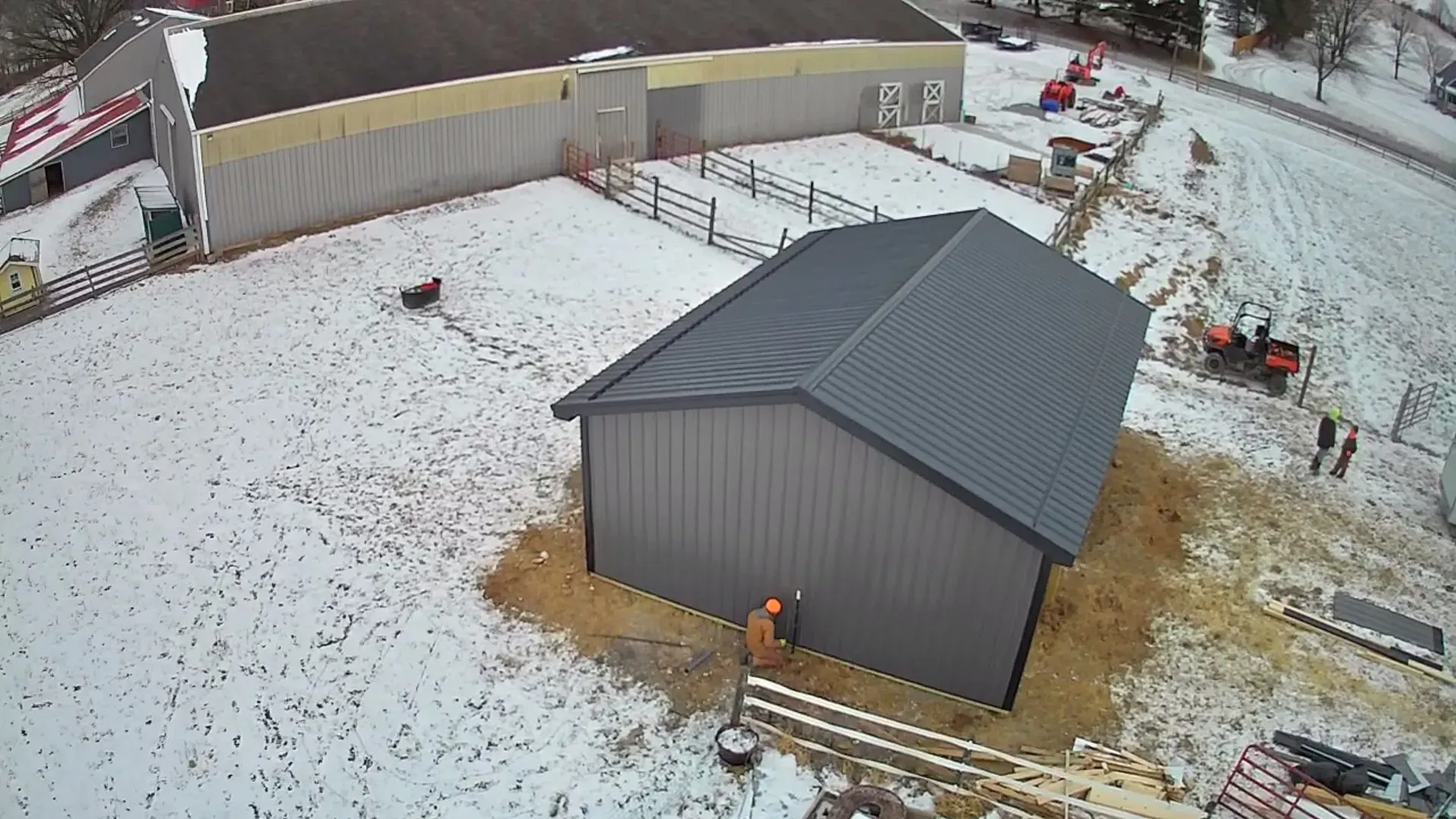 An aerial view of a building under construction in the snow