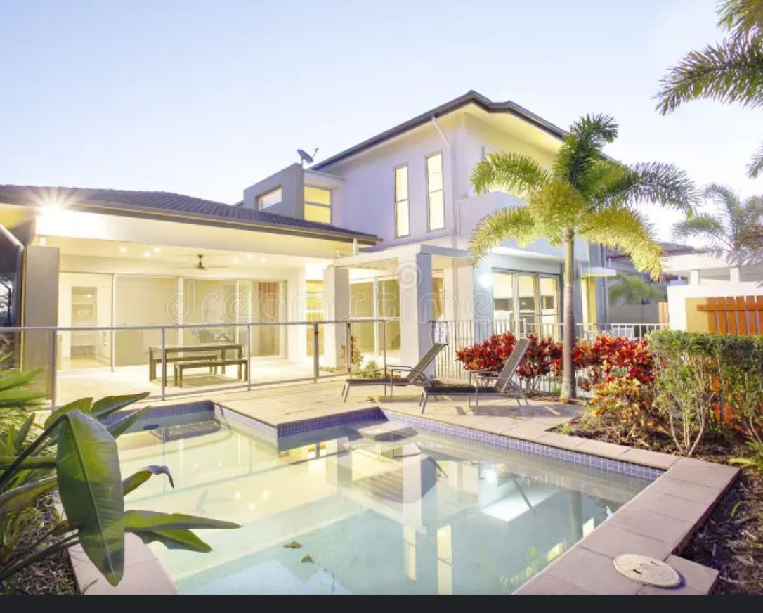 A large house with a swimming pool in front of it