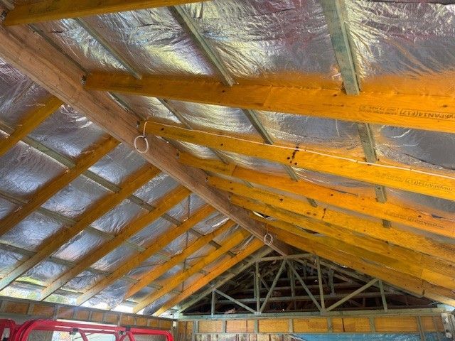 A man is working on the roof of a building.