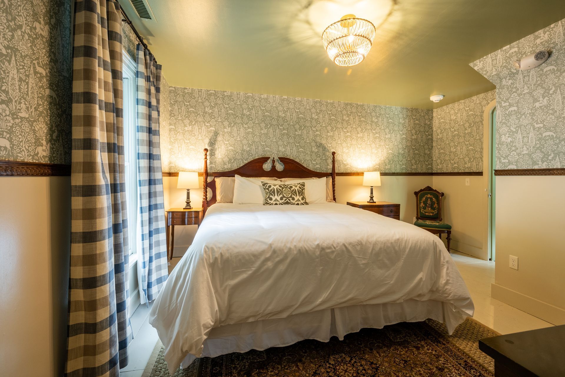 A hotel room with a king size bed and a clock on the wall.