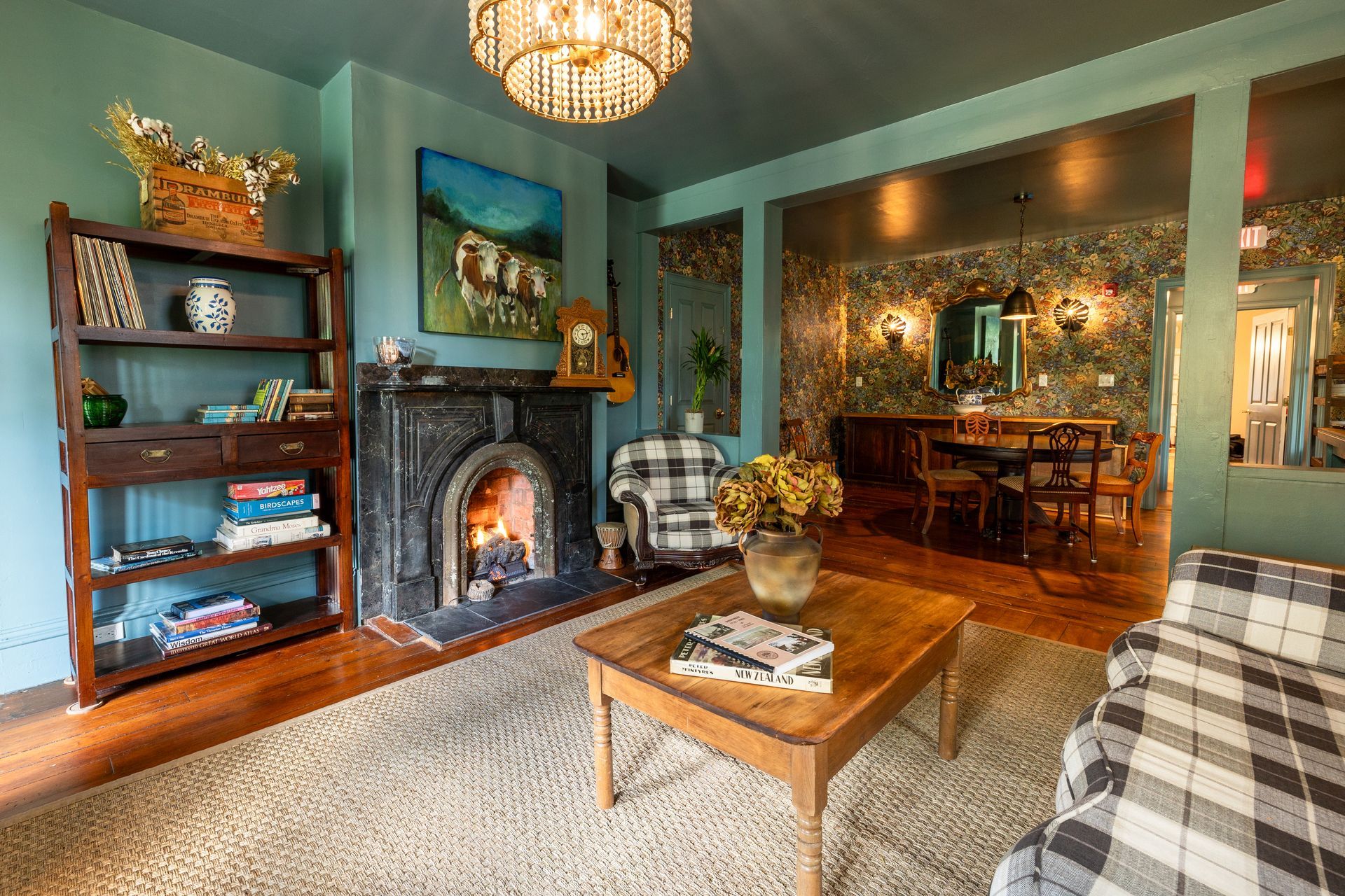 A living room with a fireplace , couch , coffee table and chairs.