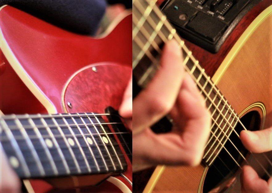 guitarist's hands on an electric guitar and an acoustic guitar