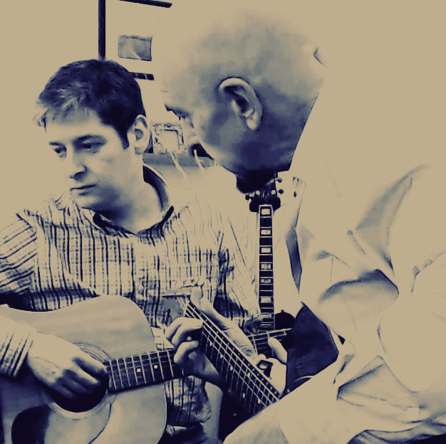 Guitar tutor David Rollins teaching a student