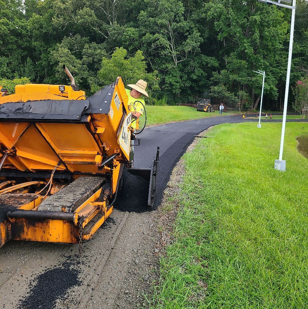 Person welding metal box; sparks fly. Gray gloves, black cable, indoor setting.