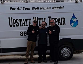 Well pump system with pressure tank and equipment exposed in an outdoor setting.