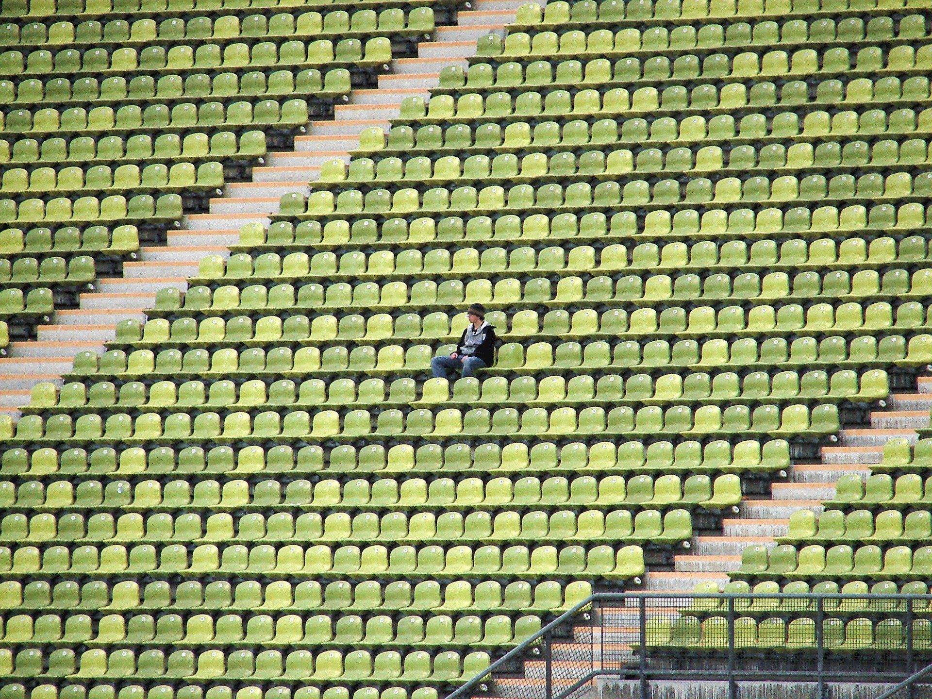 person in a chair in empty stadium