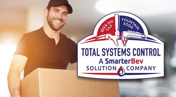 A man is holding a box in front of a total systems control logo.