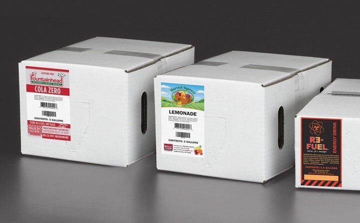 Three boxes with labels on them are sitting next to each other on a table.