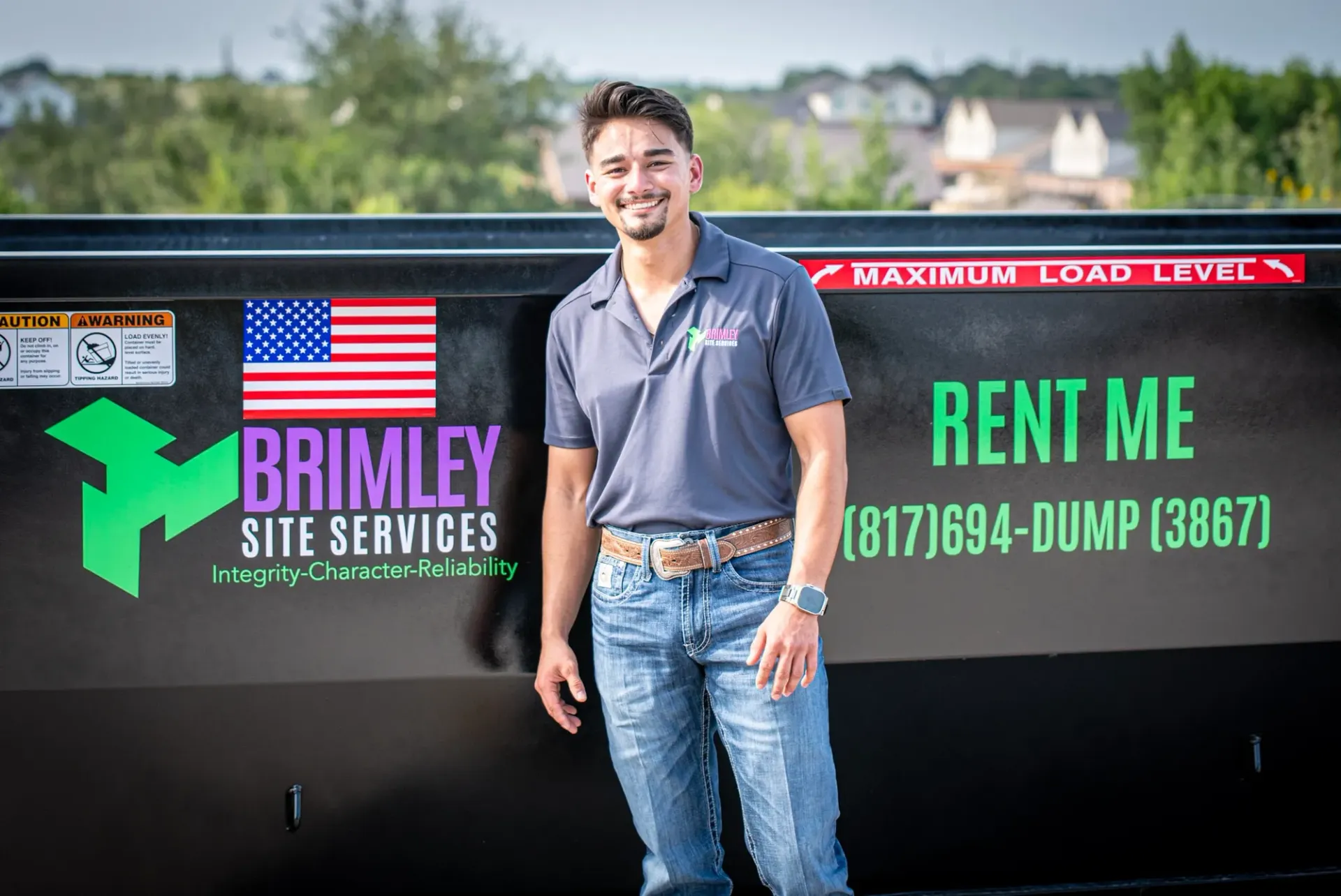 A man is standing in front of a dumpster that says `` rent me ''.