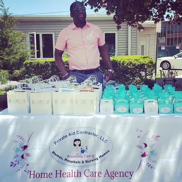 A man stands in front of a table that says home health care agency