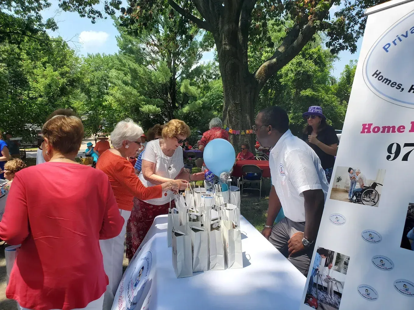 A group of people are standing around a table with a sign that says home 97