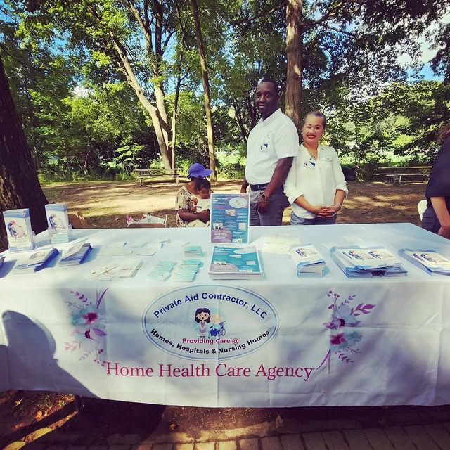 People standing around a table that says home health care agency