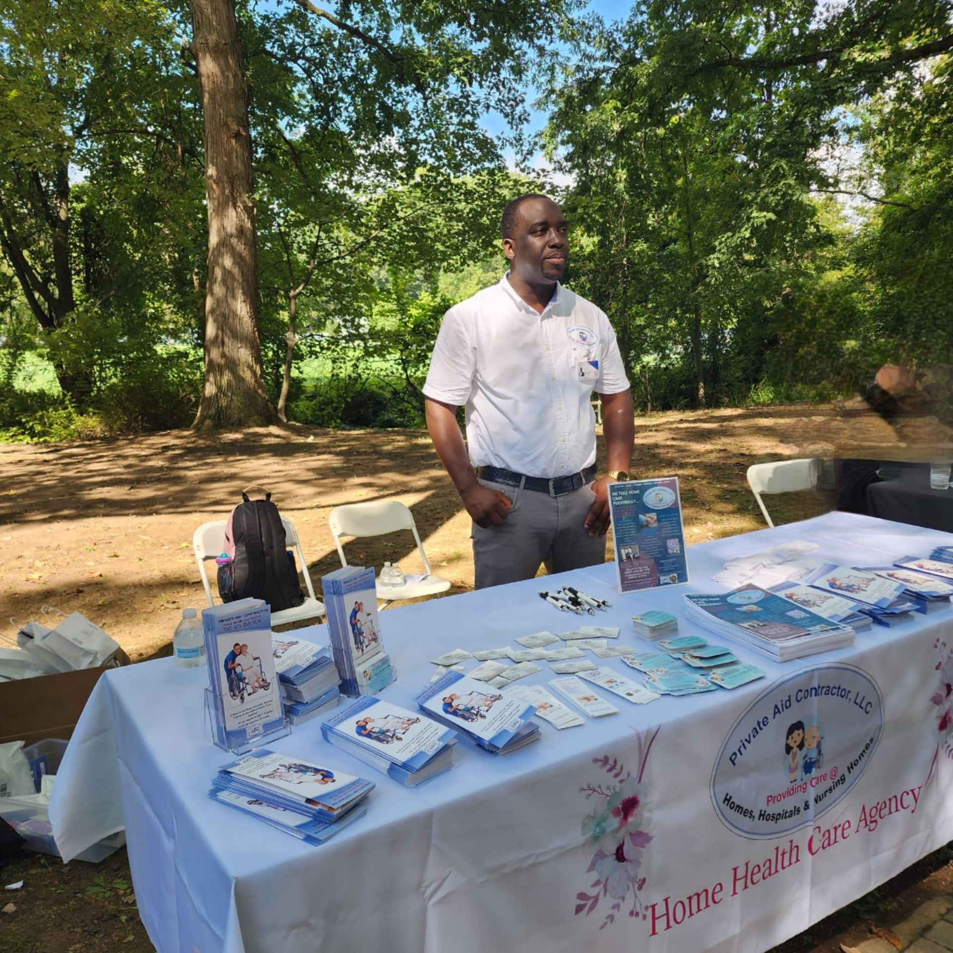 A man stands in front of a table that says home health care agency
