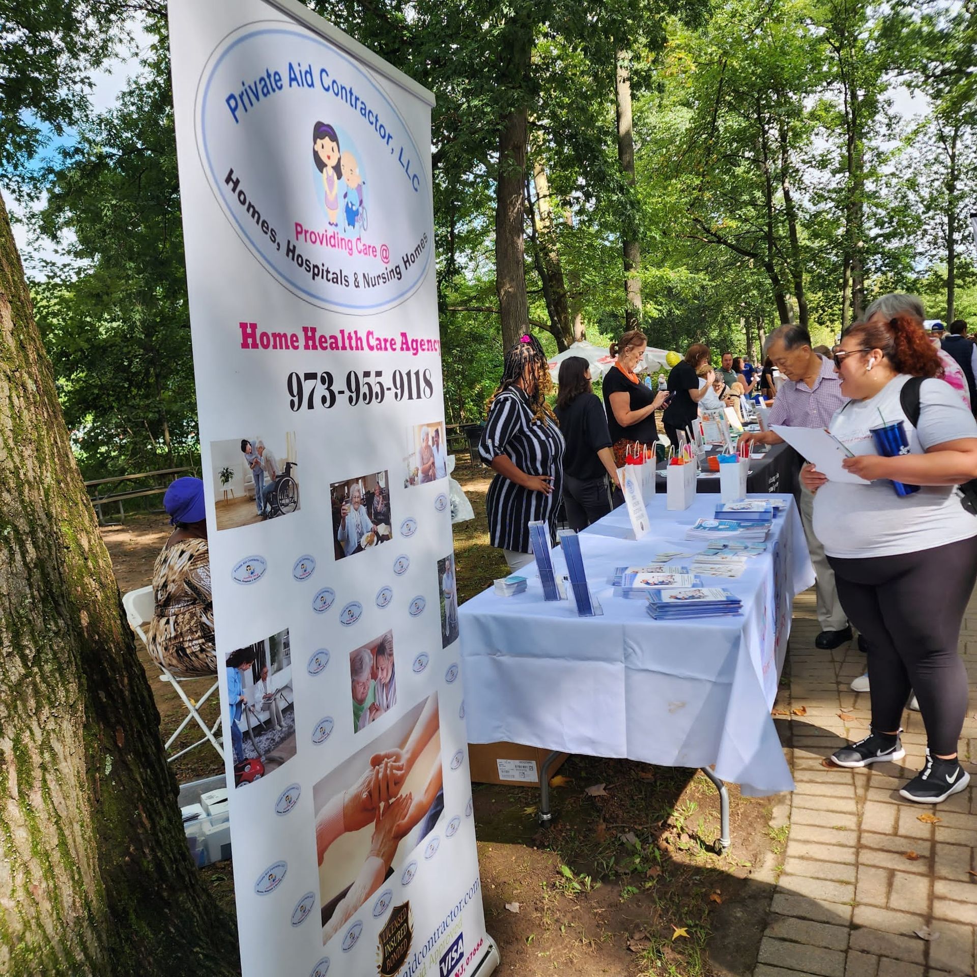 A group of people standing around a table with a sign that says home health care