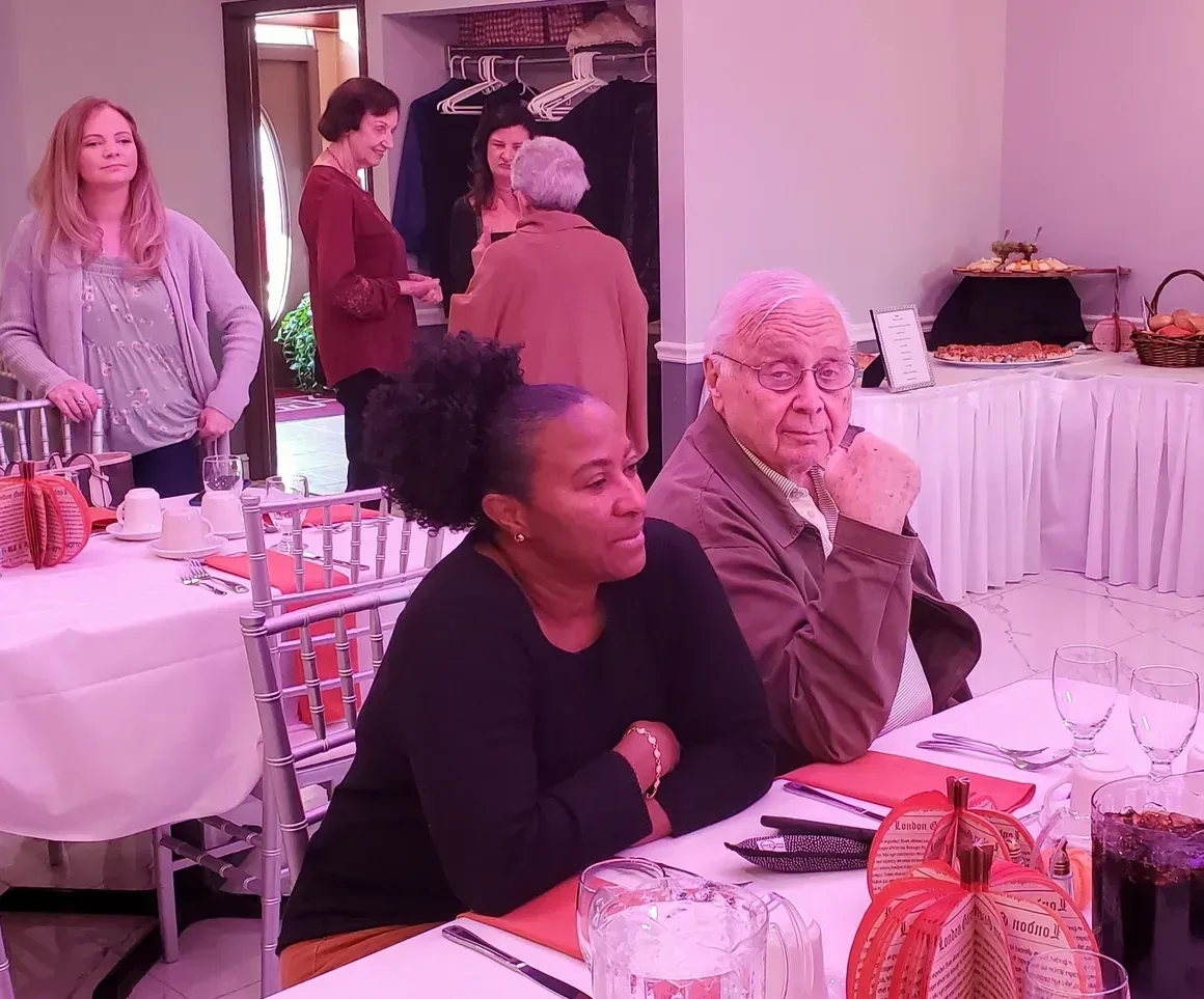 A group of people are sitting at tables in a room.