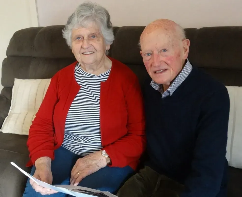 A man and a woman are sitting on a couch