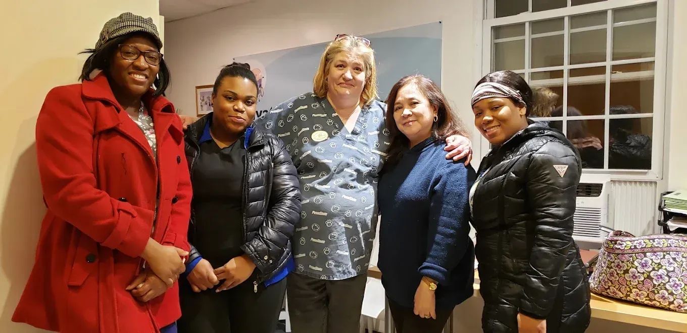 A group of women are posing for a picture together in a room.