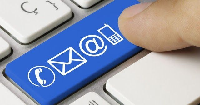 A person is pressing a blue contact button on a keyboard