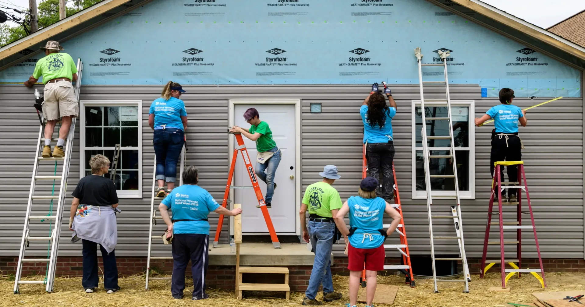 A group of volunteers build a house