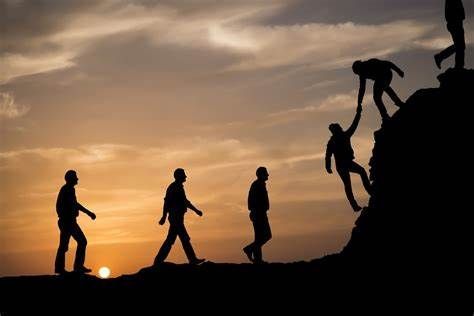 Person helping another person climb a hill