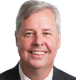 A man in a suit and tie is smiling for the camera