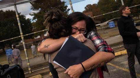 A mom excitedly hugs her daughter from prison