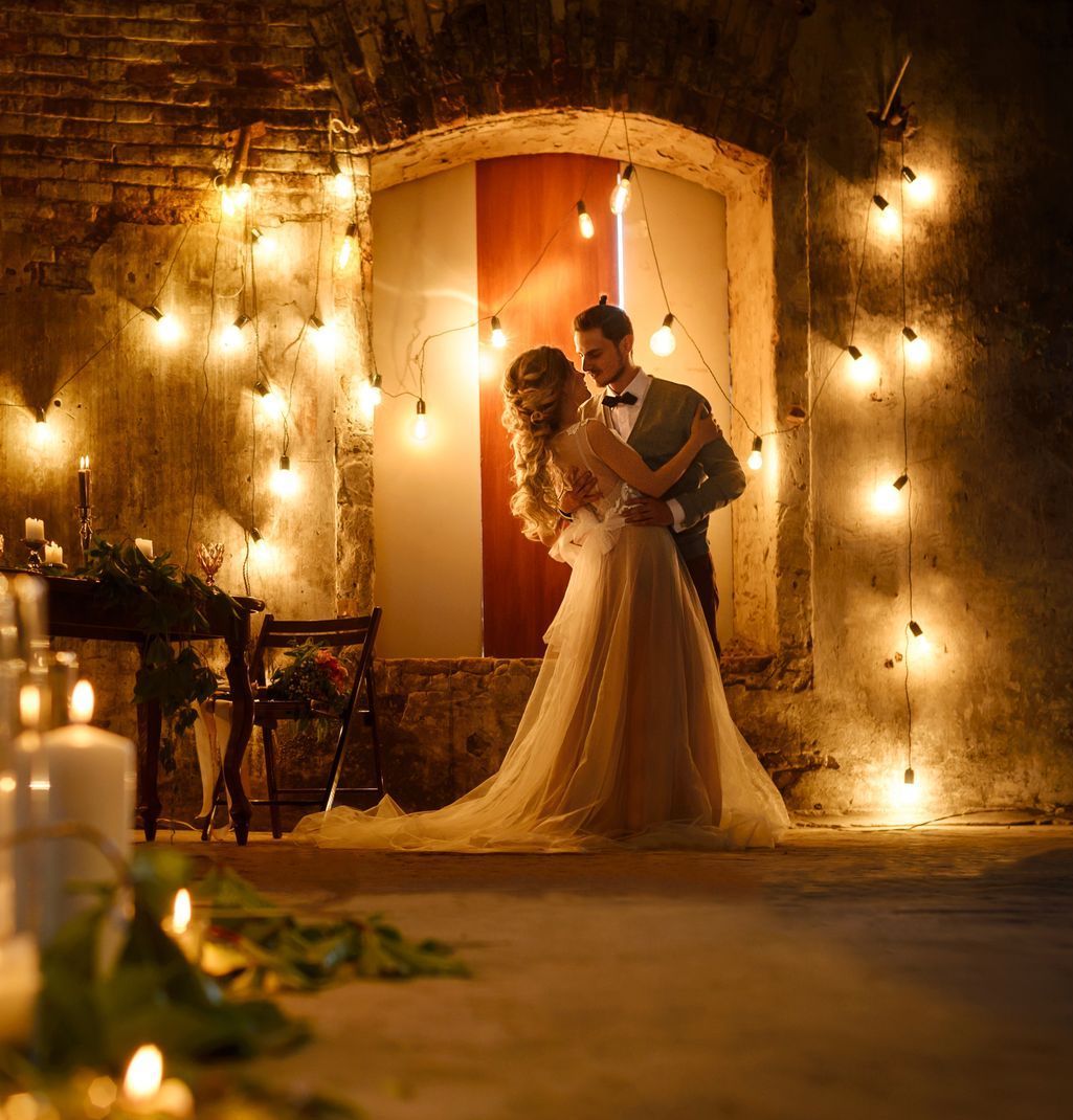 A large room with tables and chairs set up for a wedding reception.