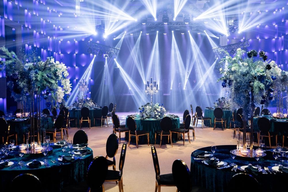 A large room with tables and chairs set up for a wedding reception.