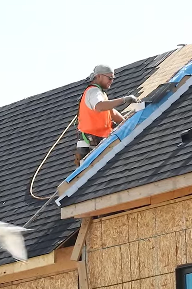 roofer fixing a house roof