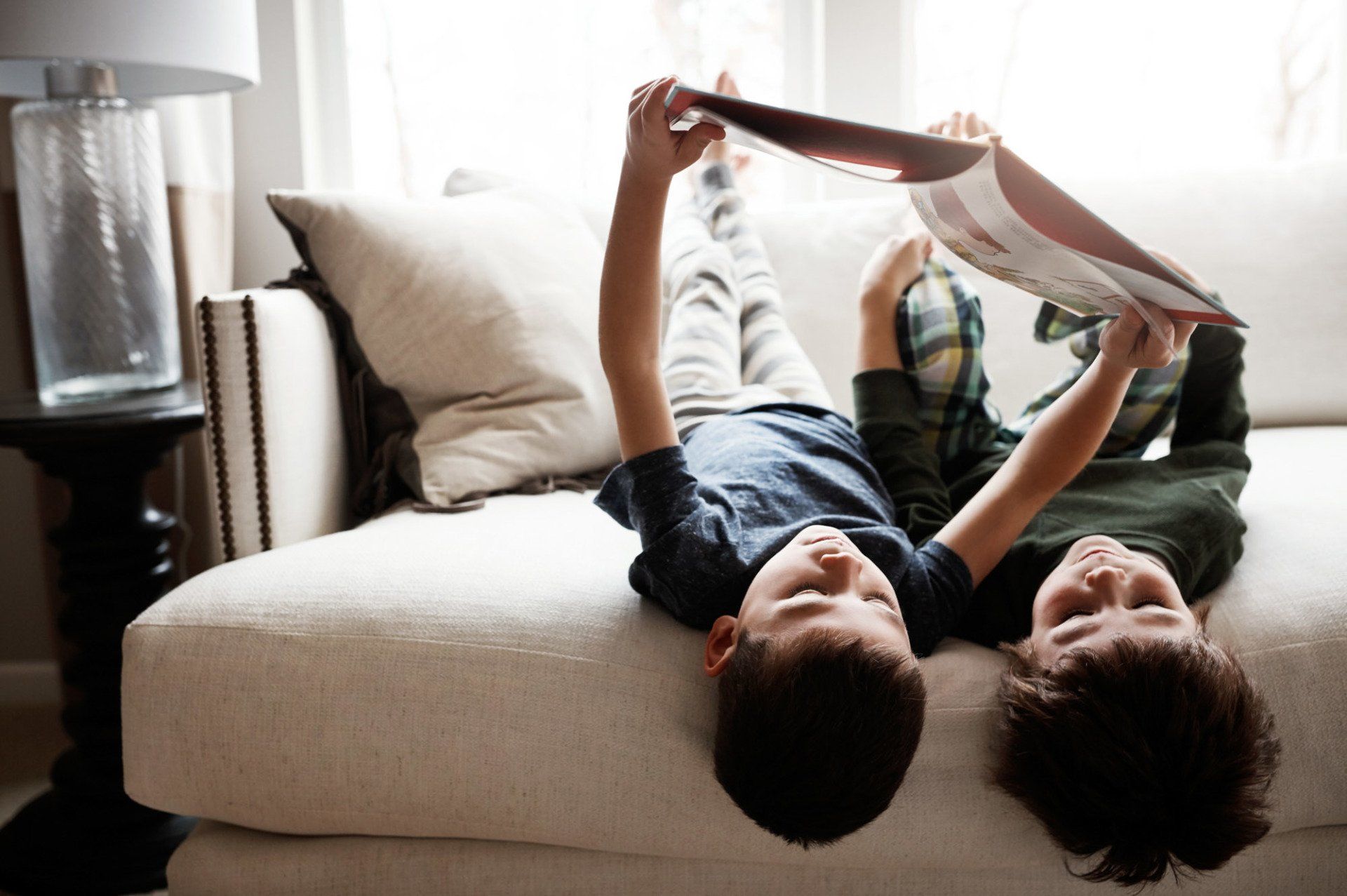 brothers reading together on a couch