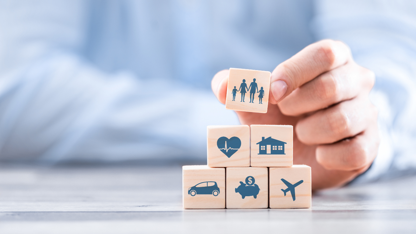 A person is stacking wooden blocks with icons on them.