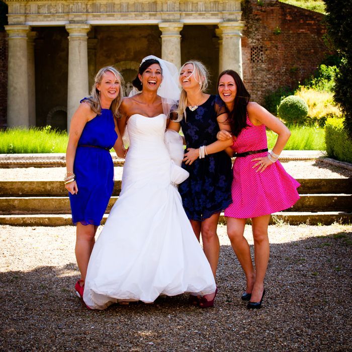 A bride and her bridesmaids pose for a picture