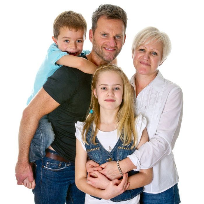 A family posing for a picture with two children
