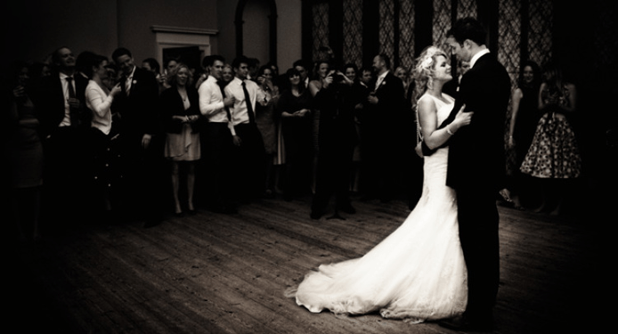 A black and white photo of a bride and groom dancing