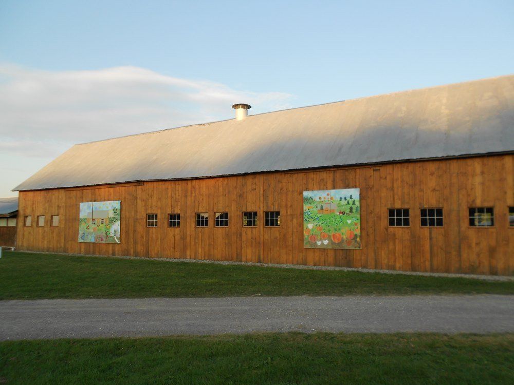 landscape photo of isham family farm with a mural