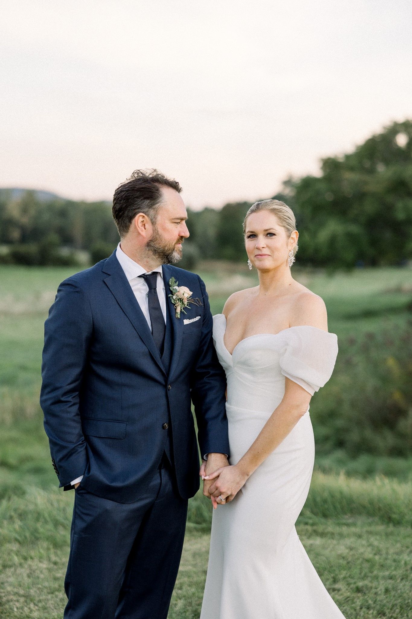 Close up shot of newly wed couple in front of the trees at isham family farm after their ceremony