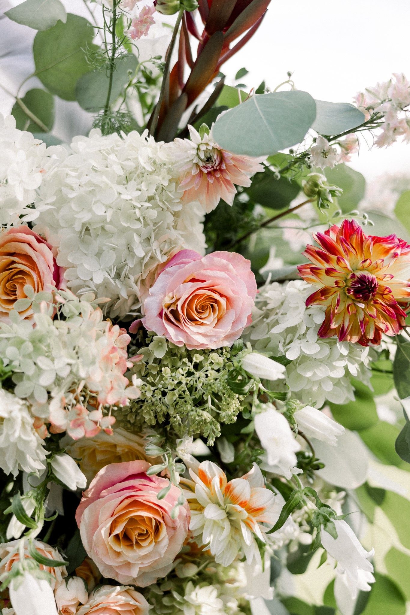 up close details shot of wedding bouquet with pink roses, zinnias, white hydrangeas and greenery