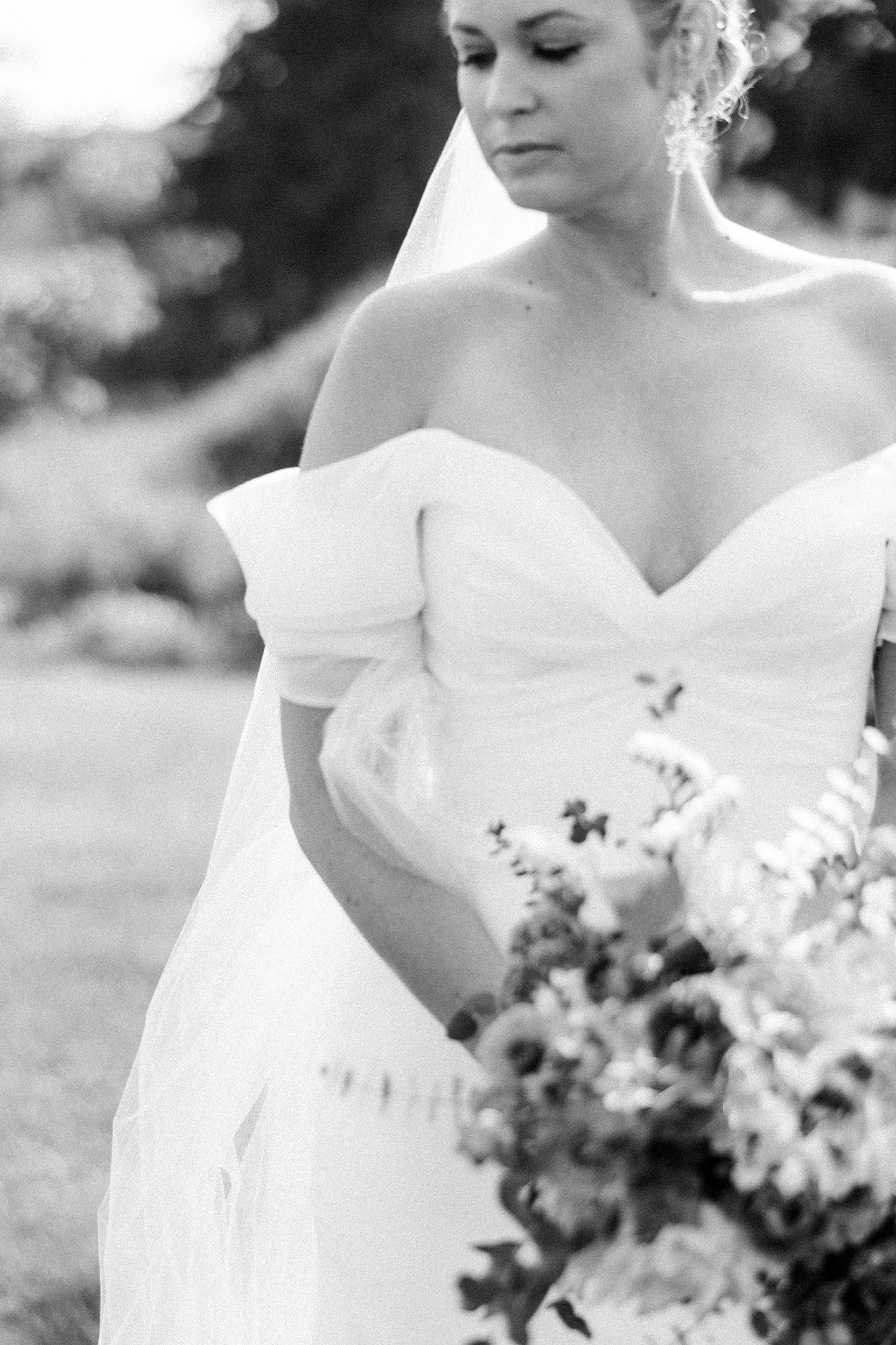 close up black and white details shot of an Isham family farm bride's wedding dress and bouquet.