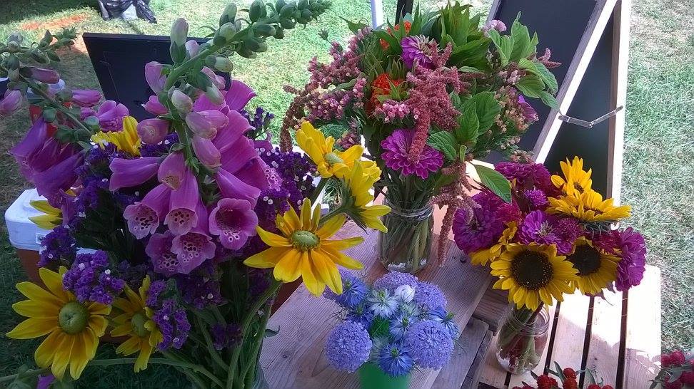 Firefly flowers vendor display close up of various flower bouquets at isham family farmer's market.