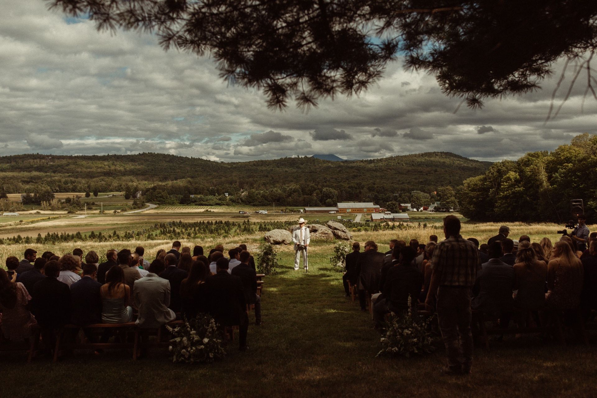 moody landscape shot of a wedding reception at isham family farm under an overcast sky