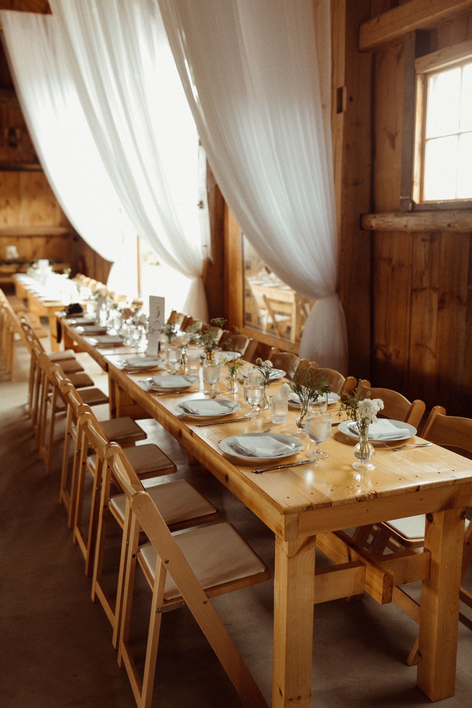 details shot of wedding reception table setting in isham family farm events barn