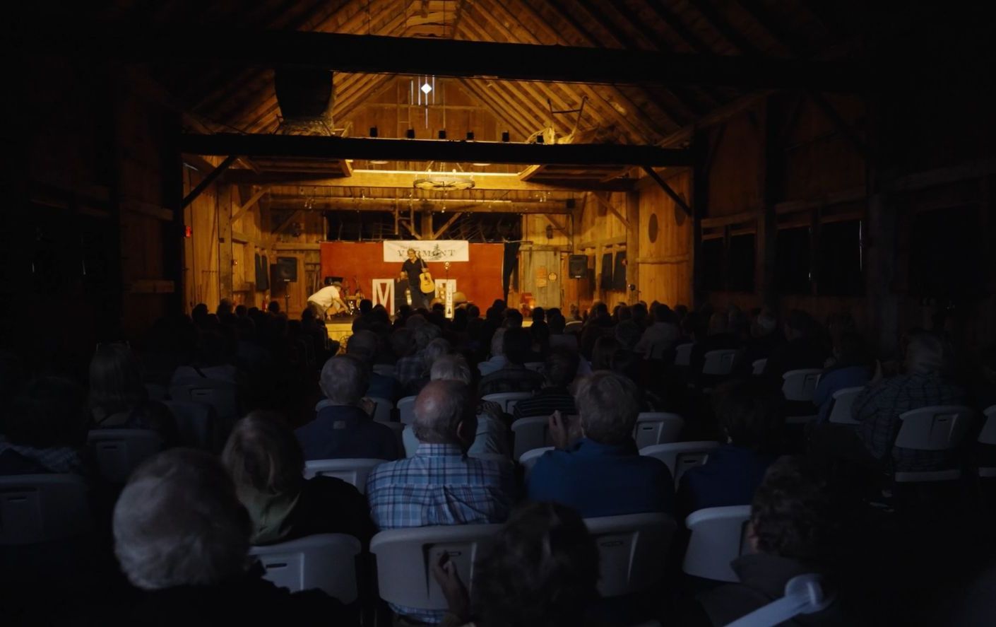 Room full of spectators watching a performance in the isham family farm events barn 
