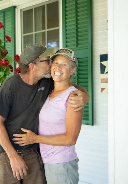 Helen and david isham in front of the main house on isham family farm