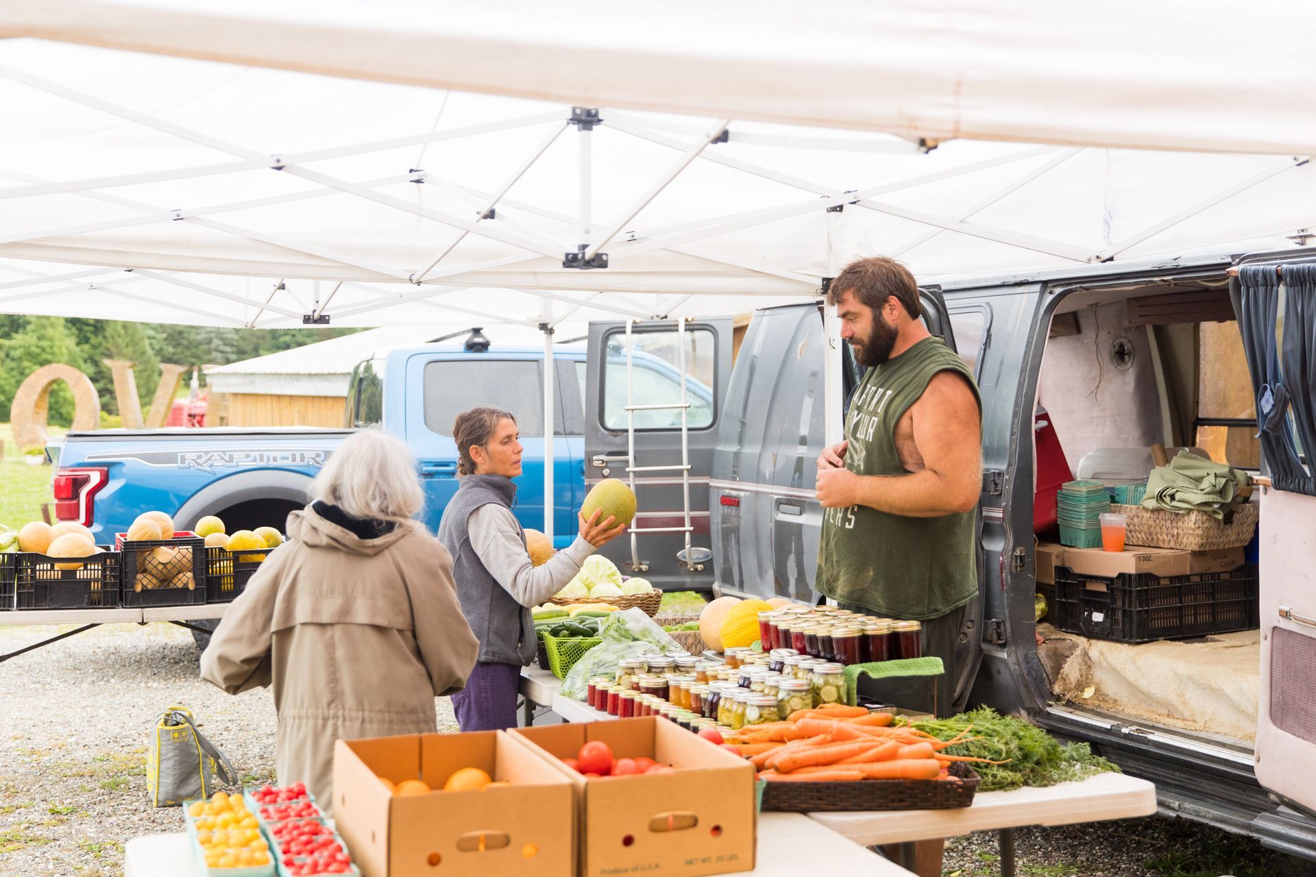 people shopping for produce at the isham family farm farmer's market