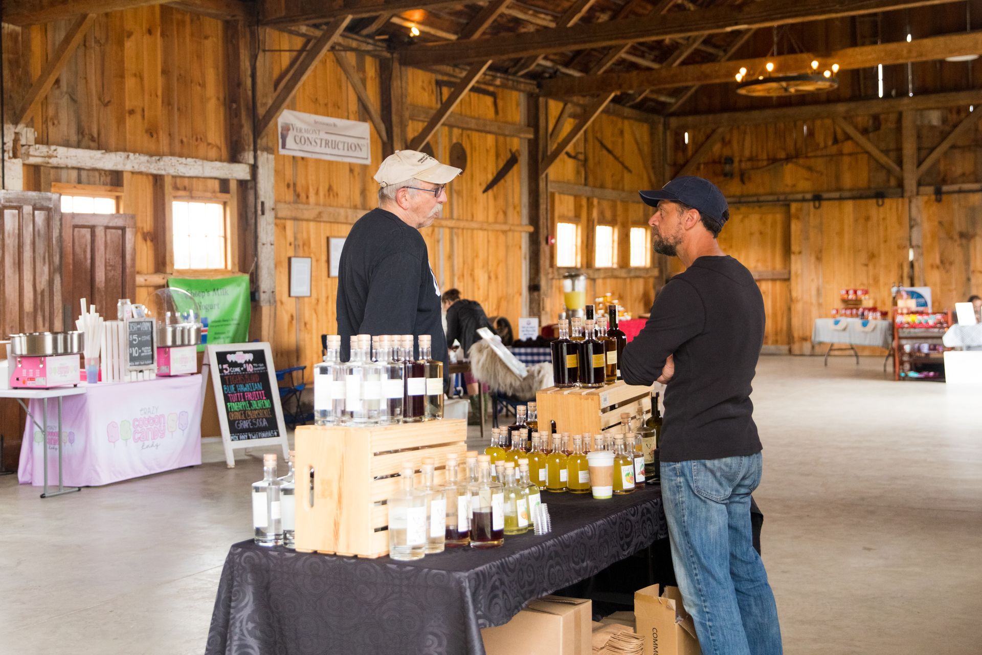 local vendor talking to a customer inside the isham family farmer's market