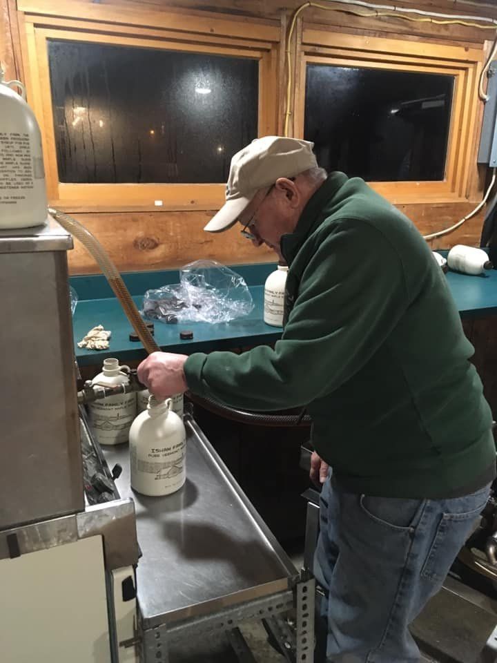 Photo of David Isham bottling fresh maple syrup