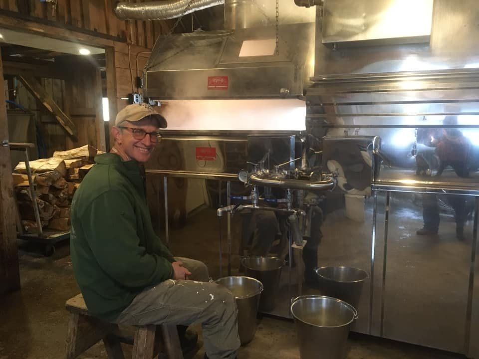 Photo of Mike Isham boiling maple syrup