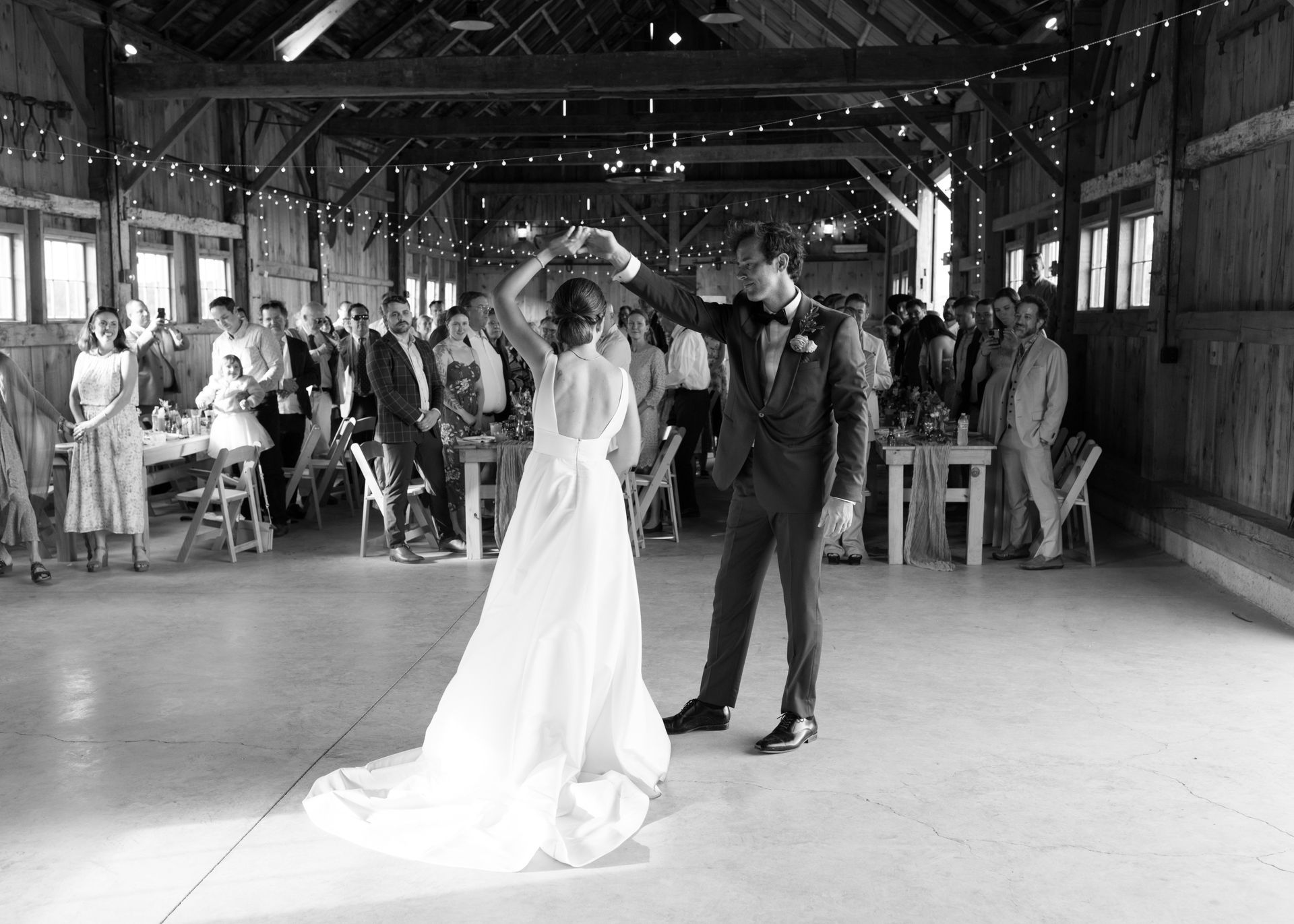 black and white photo of a couple dancing at their wedding reception at isham family farm