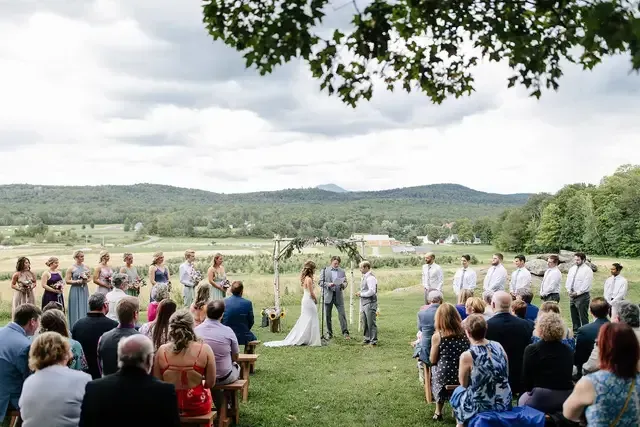 landscape shot of a wedding ceremony on a overcast spring day on isham family farm