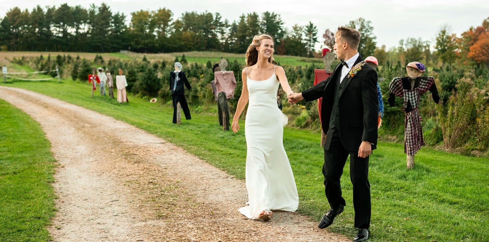 beautiful couple walking down the aisle to get married at their wedding on Isham Family Farm's property